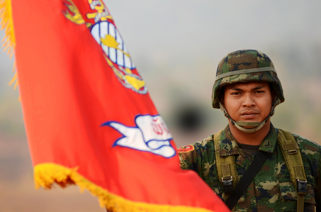 A Royal Thailand Marine holds his Corps' colors during the field training exercise opening ceremony of Exercise Cobra  Gold 2011