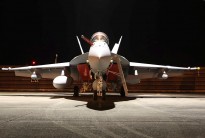 An F/A-18F Super Hornet sits under the night lights of the hangar at RMAF Base Butterworth, Malaysia during Exercise Bersama Shield 2011.