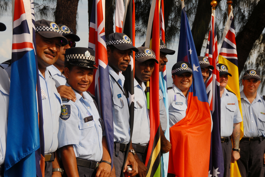 Police from across the Pacific region stand with their countries’ flags, at RAMSI’s Headquarters in 2007