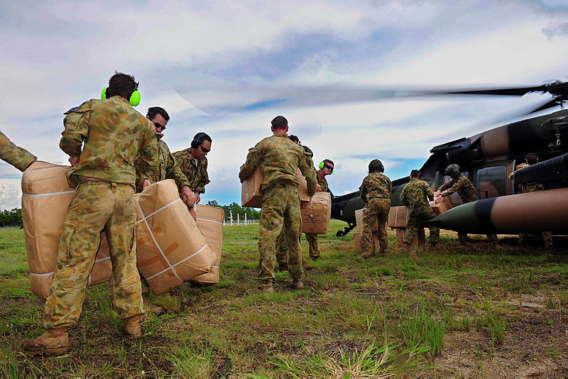 Soldiers load boxes of pillows, blankets and towels onto a Black Hawk helicopter to be transported from Rockhampton to Theodore.  The Black Hawk helicopter is from the 5th Aviation Regiment, Townsville, working as part of the Joint Task Force (JTF) 637 Operation QUEENSLAND FLOOD ASSIST.