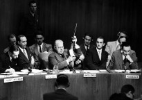 At U.N. Security Council, Warren Austin, U.S. delegate, holds Russian-made submachine gun dated 1950, captured by American troops in July 1950. He charges that Russia is delivering arms to North Koreans.