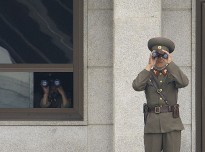 Soldiers from the Korean People's Army look south while on duty in the Joint Security Area