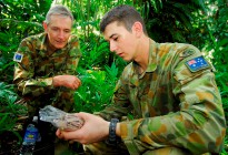 Private Marcus Bonini shows Liberal Senator Nick Minchin the contents of a ration pack 'in the field' during a visit to Solomon Islands.