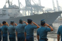 Republic of Indonesia Sailors render honors as the guided missile destroyer USS Momsen (DDG 92) arrives in Jakarta, Indonesia. Momsen, along with more than 1,000 Sailors and Marines are participating in Cooperation Afloat Readiness and Training (CARAT) Indonesia 2013.
