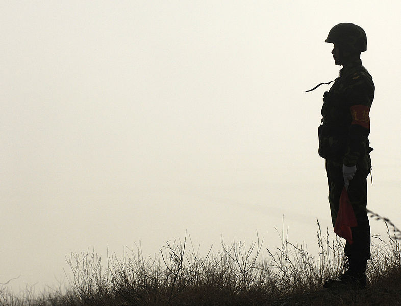 Rules of the road: a Chinese soldier with the People's Liberation Army waits to assist with American and Chinese delegation's traffic at Shenyang training base, China, March 24, 2007.
