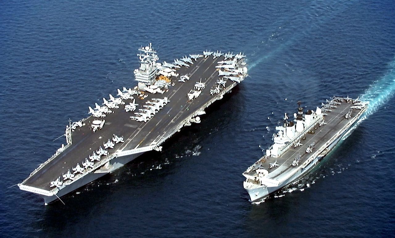 The U.S. Navy aircraft carrier USS John C. Stennis (CVN-74) (left), steams alongside the British Royal Navy aircraft carrier HMS Illustrious (R 06) in the Persian Gulf on April 9, 1998. The two ships were operating in the Persian Gulf in support of Operation Southern Watch, which is the U.S. and coalition enforcement of the no-fly-zone over Southern Iraq. DoD photo by Airman Robert Baker, U.S. Navy.