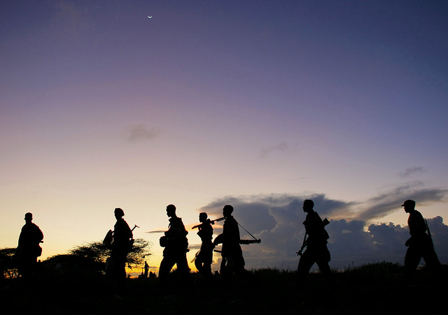 Soldiers of the Somali National Army (SNA) walk at dusk under a rising crescent moon near the outskirts of Afgooye, a town to the west of Somali capital Mogadishu. On the third day of the SNA’s joint offensive with the African Union Mission in Somalia (AMISOM), dubbed “Operation Free Shabelle”, troops have advanced to almost two kilometres outside the strategically important town, having captured along the way swathes of territory previously under the control of the Al Shabaab insurgent group. Photo ID 515019. 24/05/2012. Somalia. UN Photo/Stuart Price
