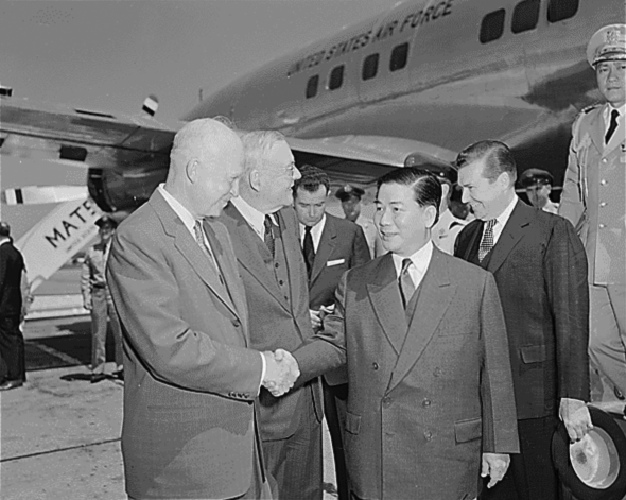 Ngo Dinh Diem, accompanied by US Secretary of State John Foster Dulles, is greeted on his arrival at Washington National Airport in May 1957 by US President Dwight D. Eisenhower