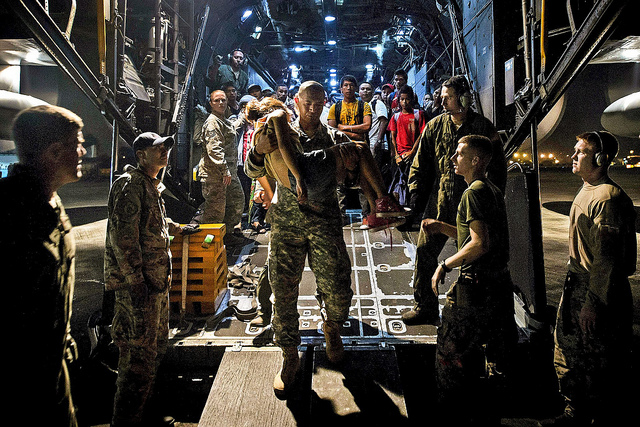 Families from Ormoc affected by Typhoon Haiyan exit an MC-130 Combat Talon II from 1st Special Operation Squadron (1 SOS) after  being transported as part of Operation Damayan