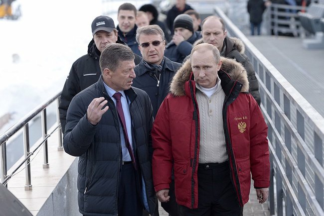 Russian President Vladimir Putin inspects Sochi 2014 facilities with Deputy Prime Minister Dmitry Kozak in January 2014
