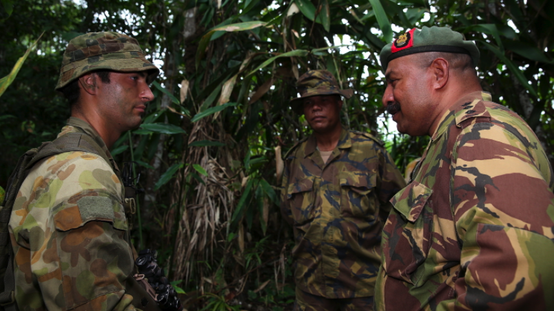Lieutenant Aaron Swanson from A Company, 2nd Royal Australian Regiment speaks with Colonel Mark Goina Chief of Personnel, PNG Defence Force and Lieutenant Colonel Vince Gabina, Commanding Officer of 2nd Battalion Royal Pacific Island Regiment, PNGDF in Wewak, PNG during Exercise Olgeta Warrior.