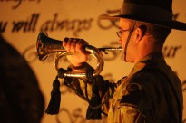 Bugler Corporal James Duquemin from the Band of the Royal Military College Duntroon plays the Last Post during the Anzac Day Dawn Service at Multi National Base – Tarin Kot.