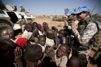 This photo shows peacekeepers from Thailand on patrol at the camp for refugees from the Central African Republic (CAR) in Muhkjar (West Darfur). They are showing the children how to greet in according to Thai tradition.