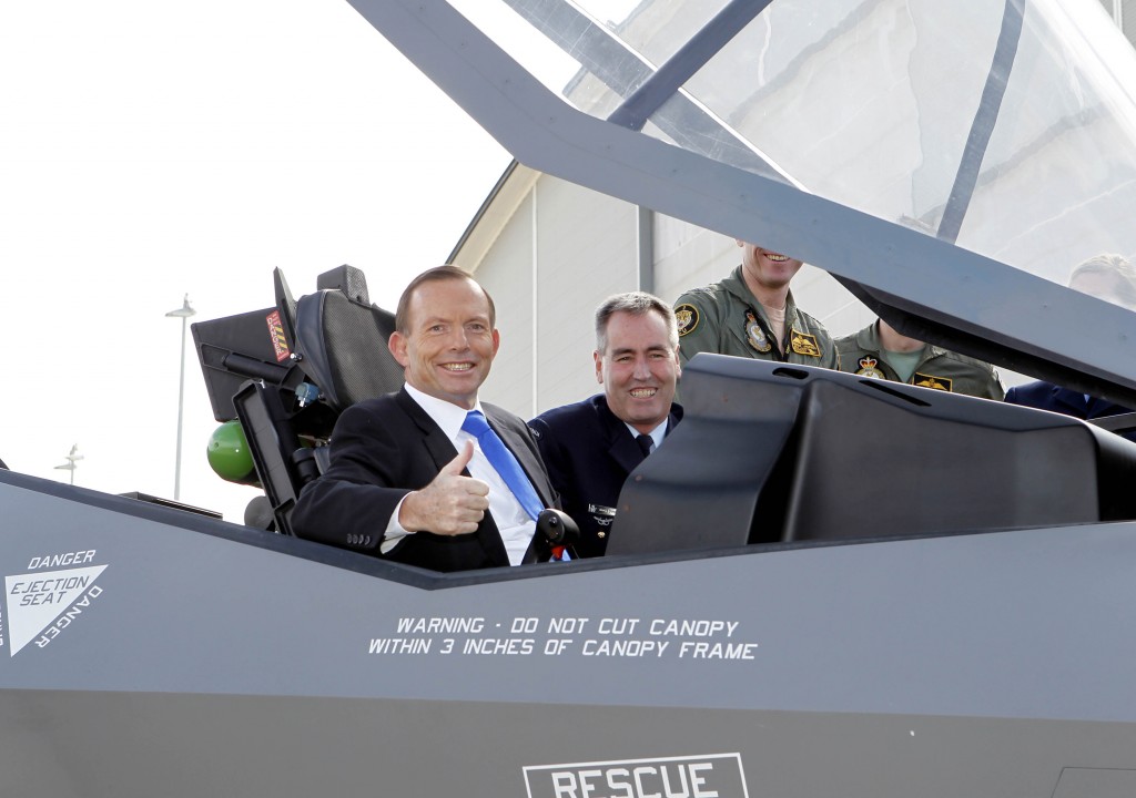 The Chief of Air Force, Air Marshal Geoff Brown, AO gives the Prime Minister, The Hon. Tony Abbott MP, a tour of the cockpit of the 'mock-up' of an  F-35A Lightning II aircraft at Defence Establishment Fairbairn.