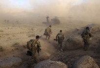 Special Operations Task Group soldiers make their way to a waiting UH-60 Blackhawk helicopter after a Shura in Sha Wali Kot, Kandahar Province, Afghanistan