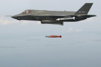 An F-35B completes a test aerial weapons release with an inert 1,000-pound GBU-32 Joint Direct Attack Munition over an Atlantic Ocean test range.