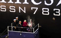 Ellen Roughead, wife of former Chief of Naval Operations (CNO) Adm. Gary Roughead and sponsor of the Virginia-class attack submarine Pre-Commissioning Unit (PCU) Minnesota (SSN 783), breaks a bottle to christen the boat.
