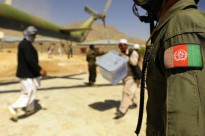 An Afghan National Air Force member looks on as civilians load ballot boxes into an Mi-17 helicopter in Jaghuri, Afghanistan, Sept. 20, 2010.
