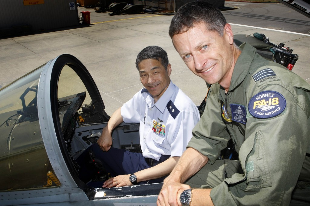 Commanding Officer No. 3 Squadron Wing Commander Timothy Alsop shows Director, Defence Planning and Policy Department, Major General Yoshinara Marumo, ASO, from the Japan Air Self-Defence Force throughout the cockpit of an F/A-18 hornet.