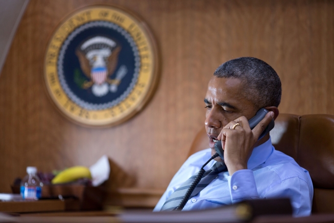 President Barack Obama talks on the phone aboard Air Force One with President Petro Poroshenko of Ukraine about the Malaysia Airlines plane crash in eastern Ukraine, July 17, 2014.