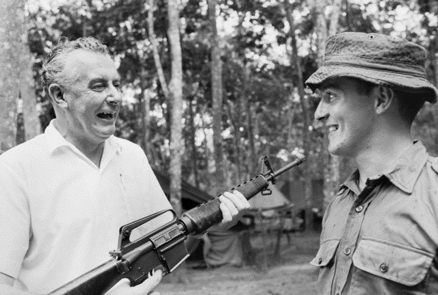 Phuoc Tuy Province, Vietnam. 10 October 1966. Gough Whitlam, then Deputy Leader of the Federal Opposition, has a laugh during a talk with Private Wayne Weldon of the 6th Battalion, Royal Australian Regiment.