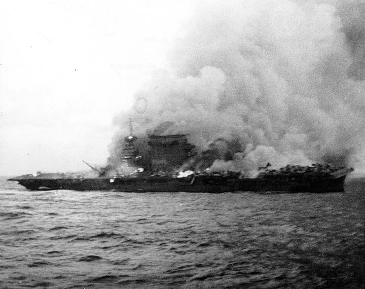 USS Lexington (CV-2), burning and sinking after her crew abandoned ship during the Battle of Coral Sea, 8 May 1942.
