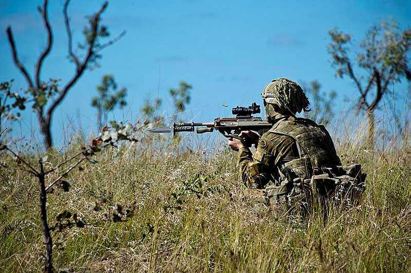 An Australian Army soldier from A Company, the 3rd Battalion, The Royal Australian Regiment fires an F88 Austeyer at an enemy position during a live fire exercise at the 3rd Brigade Combined Arms Training Activity.