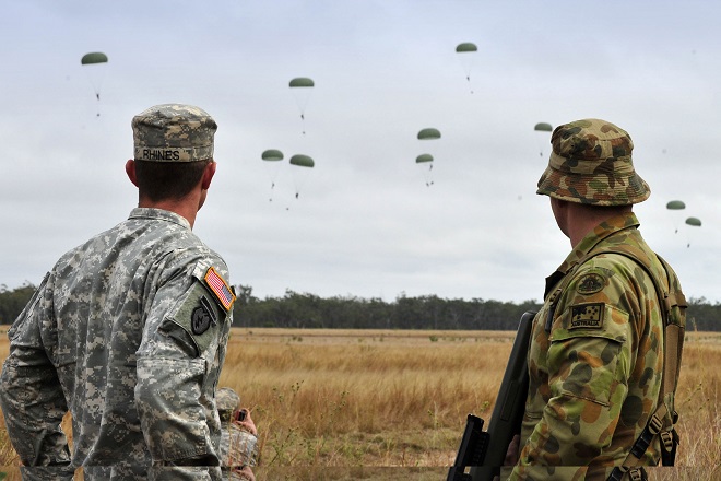 US Army Sergeant Ian Rhines and Craftsman Tyler Kernahan watch the airborne insertion of US troops from the 1st/501st Infantry Regiment into Drop Zone Kapyong as part of Exercise Talisman Sabre 2011.