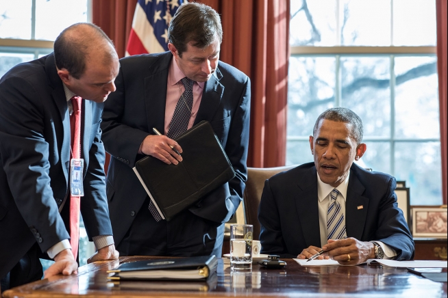 President Barack Obama works with Ben Rhodes, Deputy National Security Advisor for Strategic Communications, and Terry Szuplat, Senior Director for Speechwriting, on remarks prior to the White House Summit on Countering Violent Extremism, in the Oval Office, Feb. 18, 2015. (Official White House Photo by Pete Souza)