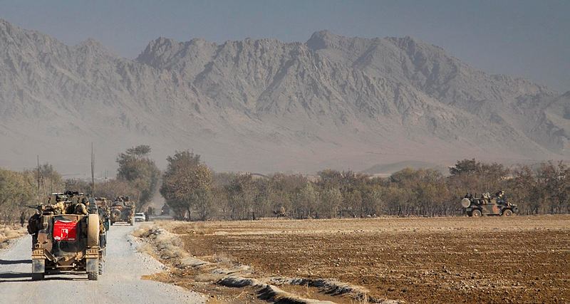Australian Bushmasters escort a Dutch crane into the Baluchi Valley, Southern Afghanistan, to facilitate repairs to an essential town bridge.