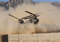 A CH-47 Chinook helicopter from C Squadron, 5th Aviation Regiment, stirs up the dust as it lands at Patrol Base (PB) Buman for the Chief of Army's visit.