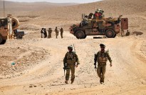 Soldiers and vehicles provide a security perimeter as the construction of a new patrol base begins in the Mirabad Valley region of Afghanistan.