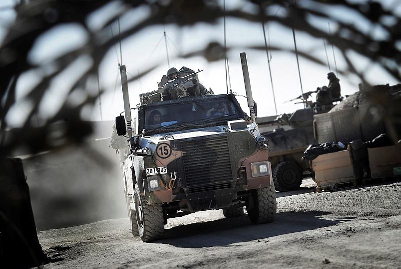 Australian soldiers depart Patrol Base Wali, Uruzgan province, Afghanistan, in a Bushmaster protective mobility vehicle and an Australian Light-Armoured Vehicle (ASLAV) heading out on a patrol during the Christmas period.