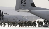U.S. Army paratroopers from the 173rd Airborne Brigade Combat Team, from Vicenza, Italy, file into a C-130J Super Hercules at Ramstein Air Base, Germany, on Feb. 10, 2012.