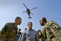 As a Black Hawk helicopter rumbles overhead, Deputy Secretary of Defense Ashton B. Carter speaks with Brig. Gen. Ron Lewis, right, during a visit to bases in Afghanistan