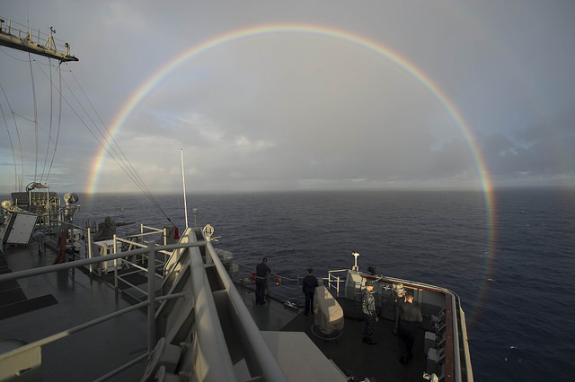 PACIFIC OCEAN (July 25, 2014) A rainbow arches near the amphibious dock landing ship USS Rushmore (LSD 47) as it transits the Pacific Ocean for a photo exercise during Rim of the Pacific (RIMPAC) Exercise 2014. 