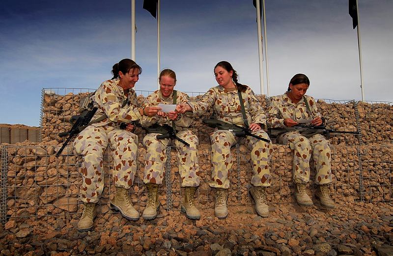 1st Mentoring and Reconstruction Task Force mothers (left to right) Sergeant Donna Bourke, Warrant Officer Class Two Cassandra Jones, Corporal Nicole Spohn and Corporal Ivona Bartusch share photos of their kids as they celebrate Mothers Day in Tarin Kowt, Afghanistan.