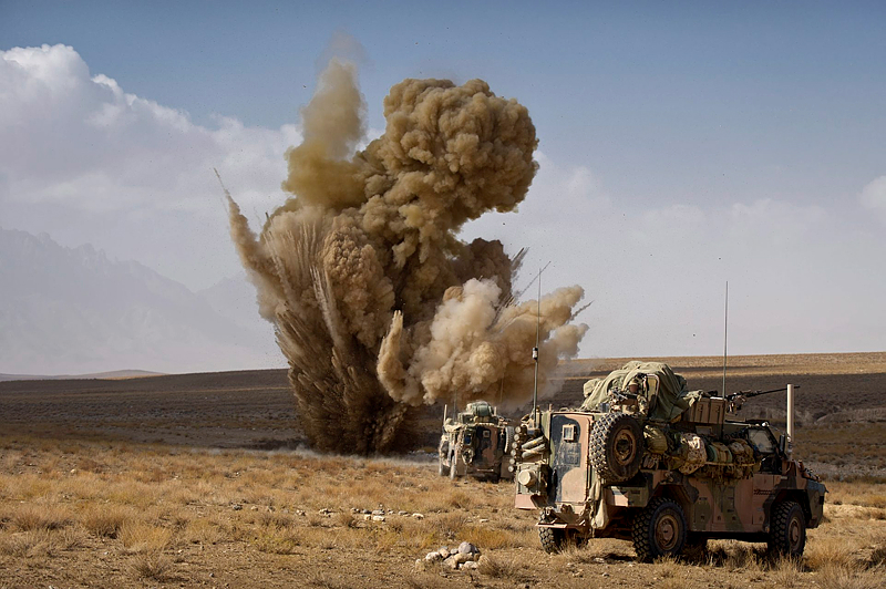 A controlled detonation of an Improvised Explosive Devise (IED) explodes in front of an Australian Bushmaster during a move down one of the most dangerous IED routes in the region to conduct disruption operation in Northern Kandahar. 