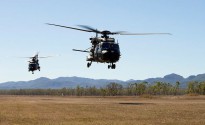 Australian Army MRH-90 Taipan multi-role helicopters depart an airfield at the beginning of a mission in Shoalwater Bay training area, near Rockhampton, Queensland, during Exercise Blue Dog 2.