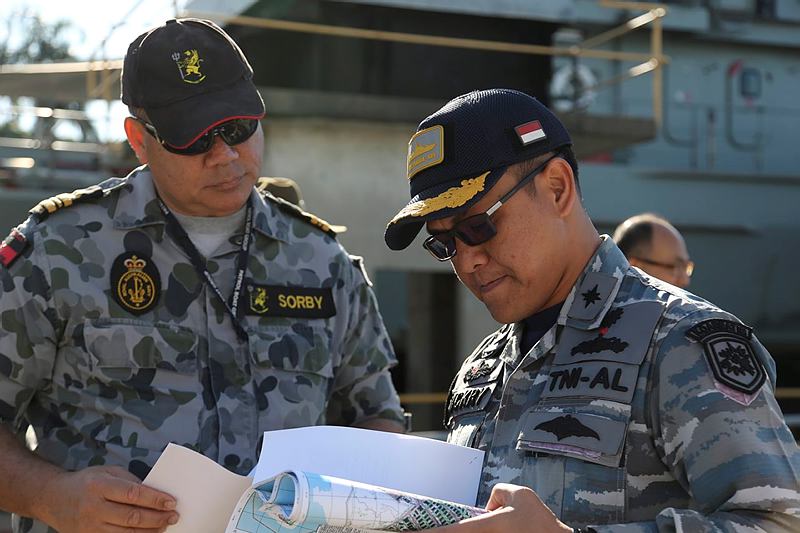 Lieutenant Commander Mark Sorby (left), from Headquarters Northern Command, provides a briefing to Lieutenant Colonel Dickry Rizanny, Commanding Officer of the Indonesian patrol boat KRI Tombak, following the successful conclusion of the 2015 Australian-Indonesian Coordinated Patrol.