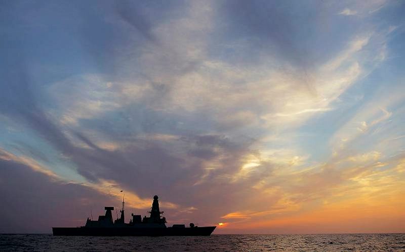 HMS Dragon crossing the setting sun during operations in the Middle East.