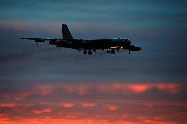 Edited USAF image of a B-52 bomber flying at sunset.
