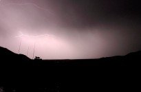 An Afghan summer storm breaks over a 1st Mentoring and Reconstruction Task Force Bushmaster Protected Mobility Vehicle during operations in the Baluchi Valley, southern Afghanistan