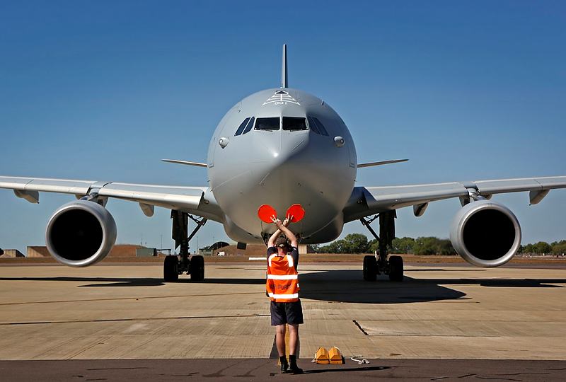 A RAAF Base Darwin Air Movements Section member marshalls in a No. 33 Squadron KC-30A Multi Role Tanker Transport aircraft as it delivers 190 personnel from the Townsville-based 2nd Battalion Royal Australian Regiment for Exercise Talisman Sabre 2015.