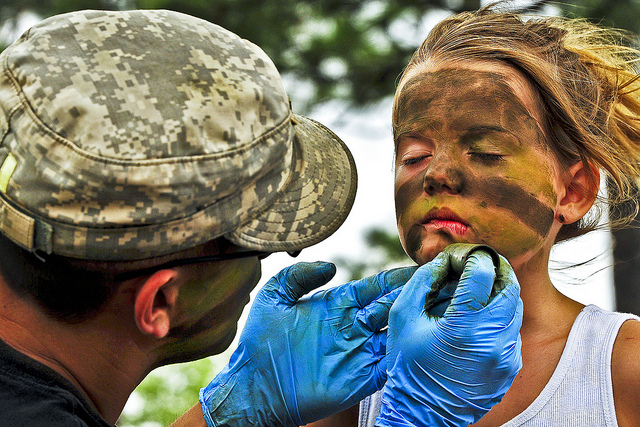 A Soldier transforms 7-year-old Kayiah into a camouflaged Army Ranger at the 6th Ranger Training Battalion’s annual open house on Eglin Air Force Base, Fla., May 12, 2012. 