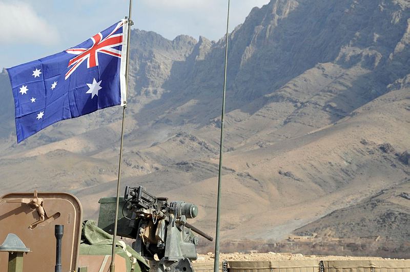 The Australian flag flies proudly above an Australian Light Armoured Vehicle parked inside an Australian and Afghan patrol base in the Baluchi Valley, Oruzgan Province.