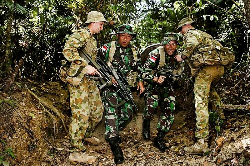 Australian Army soldiers assist Indonesian Army personnel on the Tully training area obstacle course as part of the Junior Officer Combat Instructor Training course conducted by the Australian Army's Combat Training Centre—Jungle Training Wing from 28 September to 10 October 2014.