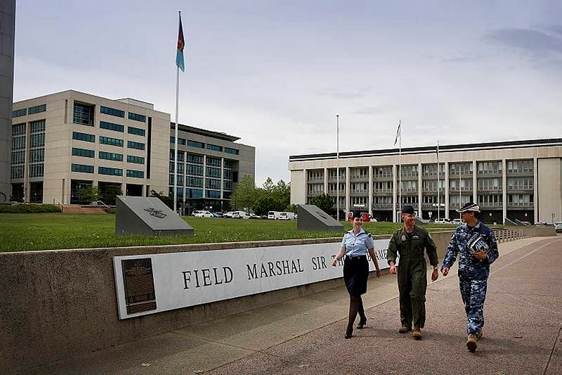 Royal Australian Air Force members Flight Lieutenant Stephanie Anderson (left), Squadron Leader Clint Huxley and Sergeant Damian Williams at the Department of Defence complex, Russell Offices, Canberra.