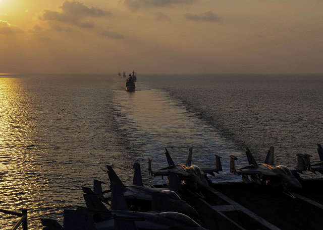 Ships from the Indian and U.S. navies, and Japanese Maritime Self-Defense Force, maneuver into a close formation during Exercise Malabar 2015.