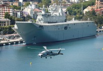 The Royal Australian Navy's latest helicopter, the MH60R 'Romeo' Seahawk, flies past the Navy's latest ship, NUSHIP Canberra in Sydney, NSW.